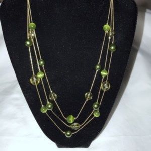 Women's gold tone triple strand necklace w/green beads